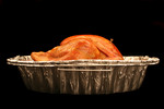 Cooked Thanksgiving Turkey in a Roasting Pan from the Side