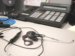 Headset and Phone on an Office Desk
