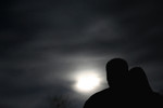 Couple Looking at the Moon at Night
