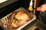 Person Buttering a Turkey With a Brush