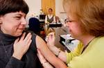 Nurse Giving a Flu Shot to Her Patient