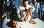Doctor Examining a Child with Polio Disease