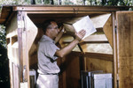 Cdc Field Researcher Moving a Mosquito Cage from a Horse Stable Mosquito Trap
