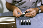 Field Researcher Labeling Glass Tubes Filled with Mosquitoes that will be used in an Arbovirus Study - 1980
