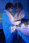 Laboratory Worker Pipetting Specimens During a Lab Experiment