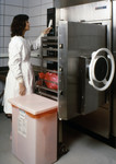 Female Scientist Working with an Early Model Autoclave System