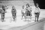 Children Riding Tricycles