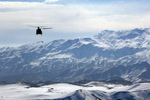 Military Helicopter Over Afghanistan Mountains