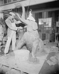Man Building an Elephant Statue