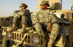 Two Female Army Soldiers on a Vehicle