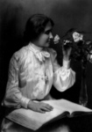 Helen Keller Smelling a Rose and Reading Braille