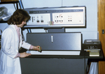 Laboratorian Using an Older Model Liquid Scintillation Counter in a Laboratory