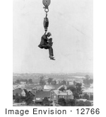 #12766 Picture Of A Photographer And Camera Suspended Above A Town