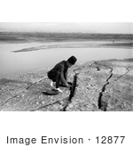 #12877 Picture Of An Arabian Man Kneeling Besides Earthquake Fissures Jordan