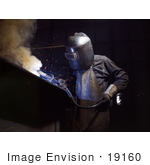 #19160 Photo Of A Welder In Protective Clothing Bending Over While Making Boilers