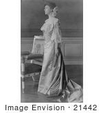#21442 Stock Photography Of Alice Roosevelt Longworth In A Gown Standing By A Chair And Holding A Folded Hand Fan