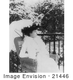 #21446 Stock Photography Of Alice Roosevelt Longworth Outdoors Sitting In A Wicker Chair Under A Parasol