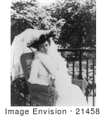 #21458 Stock Photography Of Alice Roosevelt Longworth Sitting In A Wicker Chair And Holding An Umbrella