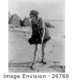 #26769 Stock Photography Of A Female Actress Myrtle Lind Holding A Camera On A Beach In 1919