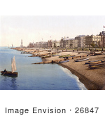 #26847 Stock Photography Of A Man Rowing A Boat Near A Beach With Boats Lined Up On The Shore And Waterfront Buildings In Herne Bay Kent South East England