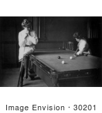 #30201 Historical Black And White Stock Photo Of A Woman Leaning On A Cue Stick And Sitting On The Edge Of A Pool Table While Watching Her Friend Play Billiards In 1903