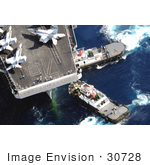 #30728 Stock Photo Of Tugboats Beside An Aircraft Carrier With Military Jets On Board In Guam