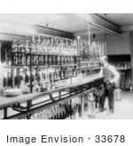 #33678 Stock Photo Of A Man A Chemical Laborator Standing At A Counter In Front Of A Line Of Bottles Testing Whiskey