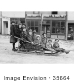 #35664 Stock Photo Of A Group Of Children Posing On A Sled In The Middle Of A Village Street In Seward Alaska