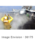 #36175 Stock Photo Of A US Navy Aviation Boatswain’S Mate Directing An F/A-18 Super Hornet Aircraft
