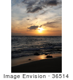 #36514 Stock Photo Of An Orange Sunset With Scattered Clouds Over The Ocean With Light Reflecting On The Wet Sand And Surf Poipu Kauai Hawaii