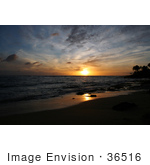 #36516 Stock Photo Of An Orange Light From A Sunset Reflecting Off Of The Wet Sand And Waves On The Pacific Ocean Poipu Kauai Hawaii