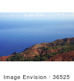 #36525 Stock Photo Of Red Na Pali Coast Cliffs Looking Over Rippling Blue Waters Of The Pacific Oceanm With Clouds In The Distance