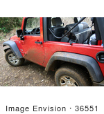 #36551 Stock Photo of The Side Of A Dirty Red Jeep Wrangler With Mud Splattered On The Side And On The Tires by Jamie Voetsch