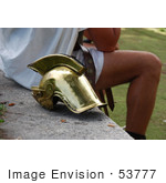 #53777 Royalty-Free Stock Photo Of A Man Sitting By A Helmet