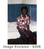 #6308 Picture of a Patient Recuperating from Lassa Fever, Sitting On a Bed in the Male Ward of the Segbwema, Sierra Leone Clinic by KAPD