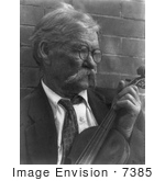 #7385 Stock Photograph Of A Man Holding Violin