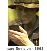 #8868 Picture Of A Soldier Applying Camouflage Paint