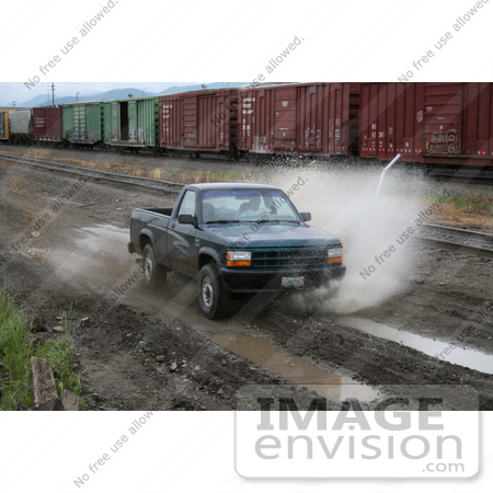 #12 Picture of an Off-Road Enthusiast Driving Through Muddy Terrain by Kenny Adams