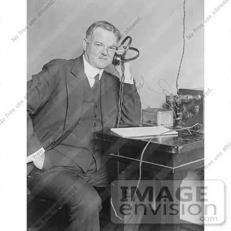 #20291 Historical Stock Photo: President Herbert Hoover Holding Headphones to His Ear to Listen to the Radio by JVPD