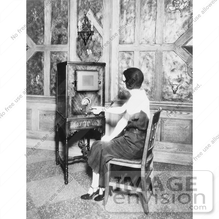 #20803 Stock Photography of a Woman Sitting in a Chair and Tuning a Radio by JVPD