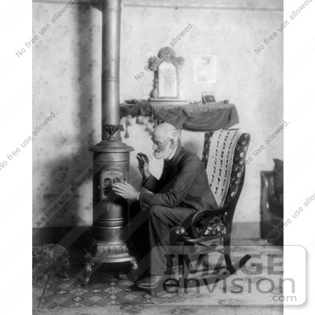 #20883 Stock Photography of an Old Man in a Rocking Chair, Cuddling up to a Stove to Keep Warm by JVPD