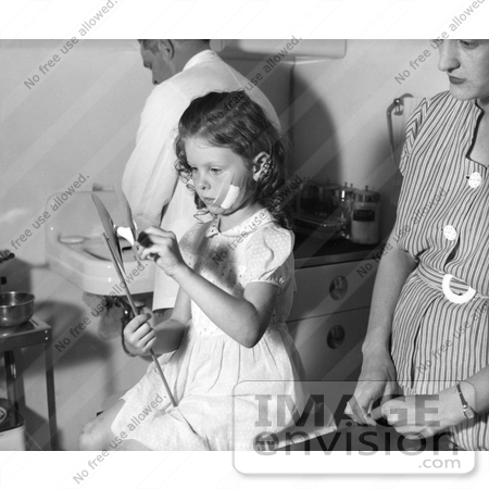 #21593 Stock Photography of a Little Girl Playing With a Toy in a Doctors Office, a Bandage on Her Face, in a Hospital After Being Bitten by an Animal That May Have Had Rabies by JVPD