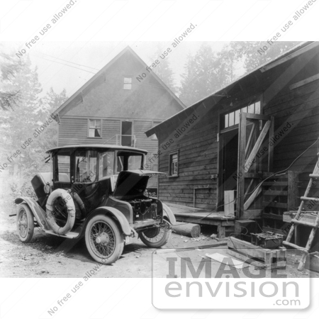 #21615 Historical Stock Photo of a Detroit Electric Automobile Parked by a Building, an Electric Cable Charging the Battery by JVPD