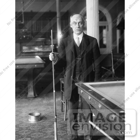 #21673 Stock Photography of George F. Slosson Standing by a Pool Table in a Billiards Room, Holding a Cue Stick by JVPD