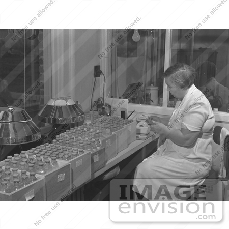 #21679 Stock Photography of a Woman Labeling Bottled Vaccines in a Laboratory by JVPD