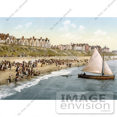 #21761 Historical Stock Photography of People Crowding on the Beach as a Yacht Starts Off From Clacton-on-Sea, Essex, England by JVPD