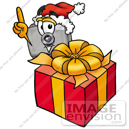#23189 Clip Art Graphic of a Flash Camera Cartoon Character Standing by a Christmas Present by toons4biz