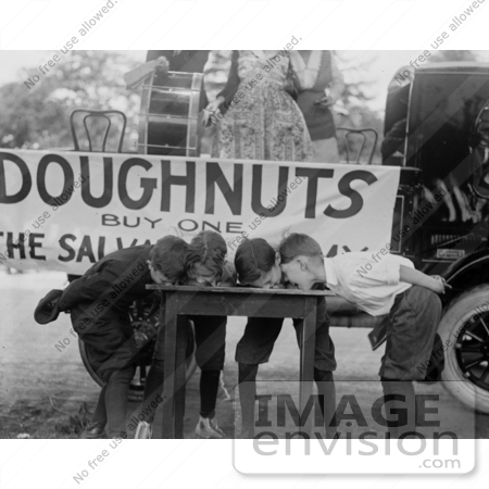 #27875 Stock Photo of Four Boys With Their Hands Behind Their Backs, Bending Over And Eating Donuts During A Doughnut Eating Contest On May 5th 1922 by JVPD