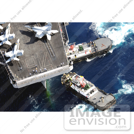 #30728 Stock Photo of Tugboats Beside An Aircraft Carrier With Military Jets On Board In Guam by JVPD