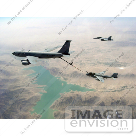 #35230 Stock Photo of a U.S. Navy F/A-18F Super Hornet Aircraft Flying Near A U.S. Air Force KC-135R Stratotanker Refueling A U.S. Navy Ea-6b Prowler Over Helmand, Afghanistan by JVPD